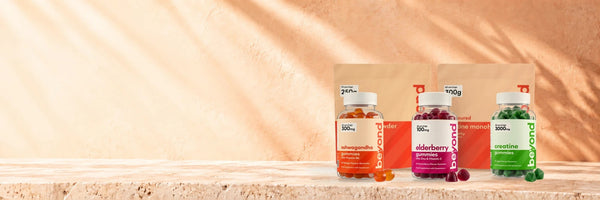 Beyond supplements: electrolyte powder, creatine monohydrate, and ashwagandha, elderberry and creatine gummies on a sunlit stone shelf