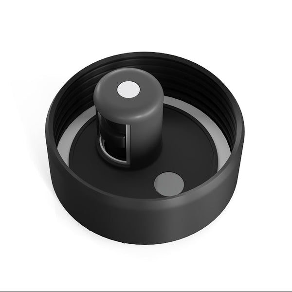 A black plastic replacement cap or lid component with a threaded outer ring, a central cylindrical protrusion, and small circular details, shown on a plain white background.